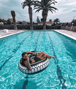 Woman relaxing in swimming pool