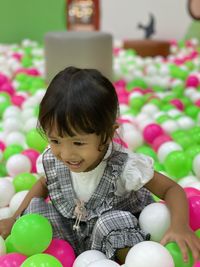 Portrait of cute girl holding balloons