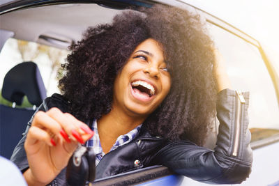 Smiling young woman in car