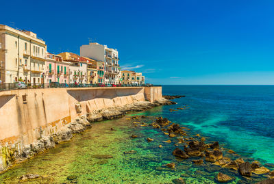 Scenic view of sea against clear blue sky