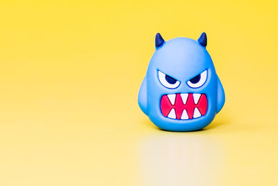 Close-up of stuffed toy against yellow background