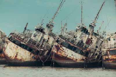 Several phinisi shipwrecks just piled up in the waters of the port of paotere, makassar, indonesia.