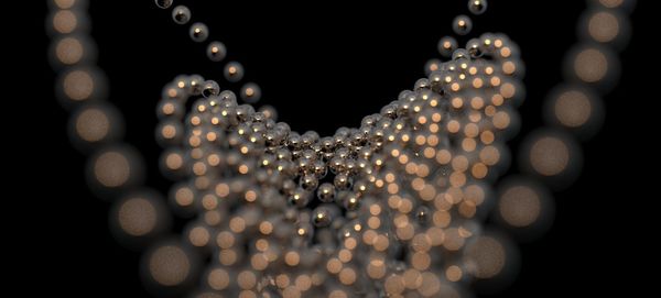 Close-up of illuminated lighting equipment on black background