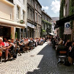 People on street amidst buildings in city