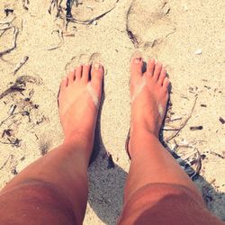 Low section of woman standing on beach