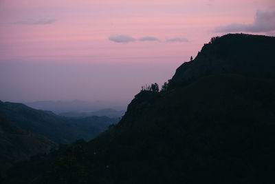 Scenic view of silhouette mountains against sky at sunset