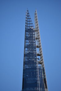 Low angle view of skyscraper against clear blue sky