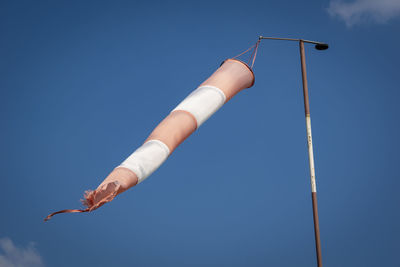 Low angle view of pole against blue sky