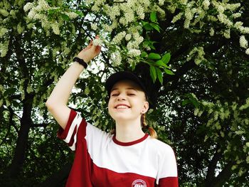 Portrait of boy standing against trees