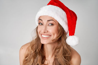 Portrait of a smiling young woman against white background