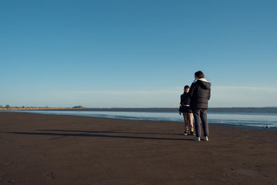 Mother and son walking by the beach