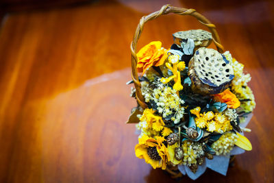 Close-up of yellow flowering plant on table