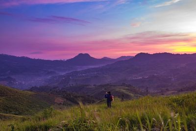 Full length of man on field against sky during sunset