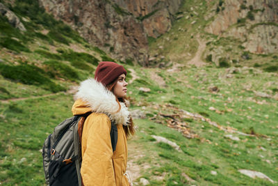 Side view of woman standing in forest