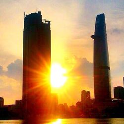 Low angle view of buildings against sky at sunset