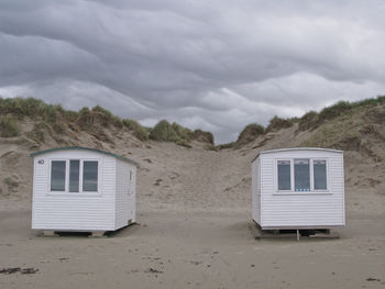 Built structure on beach against sky