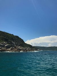 Scenic view of sea against blue sky