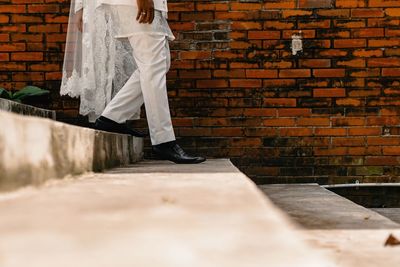 Low section of woman walking on footpath