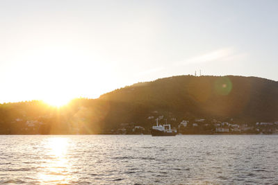 Scenic view of sea against clear sky during sunset