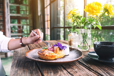 Midsection of man holding food on table