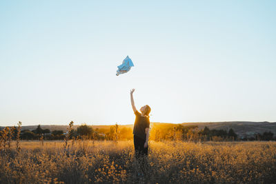 Man standing on field against clear sky