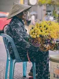 Portrait of woman sitting on bench