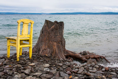 Wooden structure on beach against sky