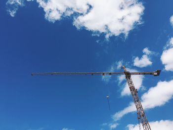 Low angle view of crane against blue sky