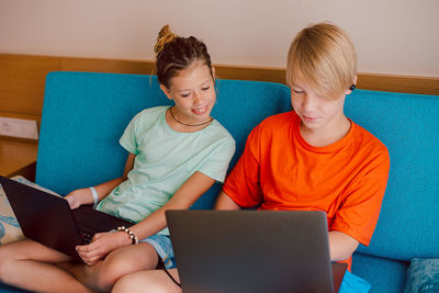Kids using laptop while sitting at home
