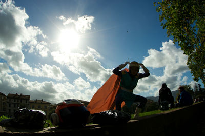 Low angle view of men against sky