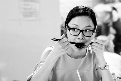 Thoughtful woman eating while sitting in restaurant