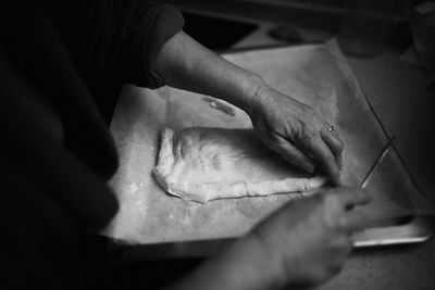 Cropped hands of woman preparing food at home