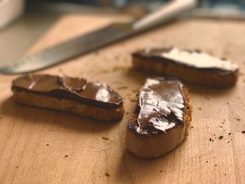 Close-up of chocolate on breads over cutting board