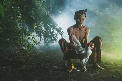 Young man sitting on chair