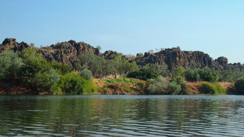 Scenic view of lake and mountains against clear sky