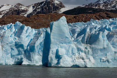 Scen
ic view of frozen sea against mountain