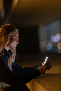 Portrait of young woman using mobile phone