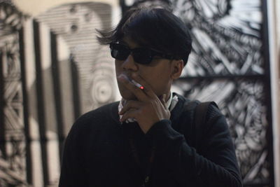Young man smoking cigarette