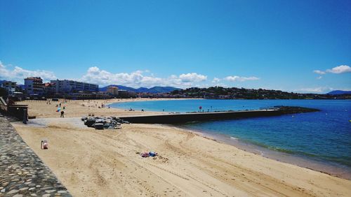 Scenic view of beach against blue sky