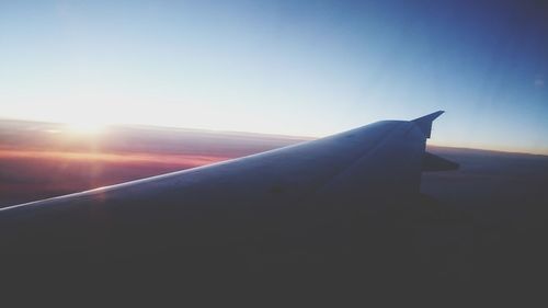 Close-up of airplane wing against clear sky