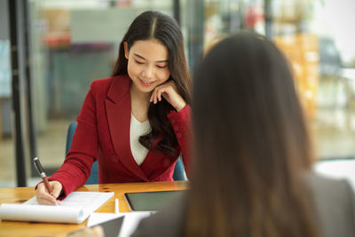 Beautiful businesswoman working with colleague at office
