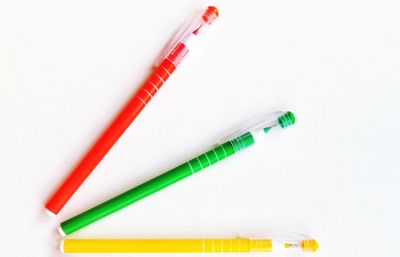 High angle view of colored pencils against white background