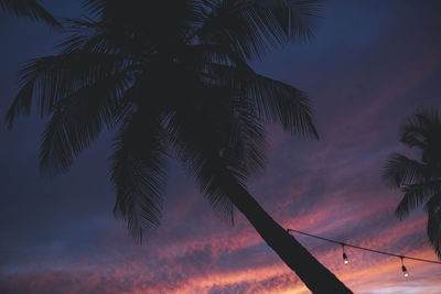 Low angle view of silhouette palm trees against sky at sunset