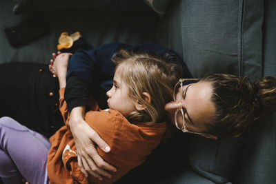 Rear view of mother and daughter in car
