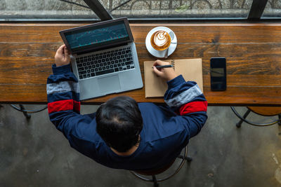 High angle view of man using mobile phone