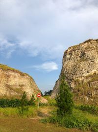 Road by mountain against sky