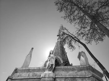 Low angle view of angel statue against clear sky