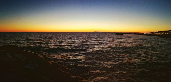 Panoramic shot of sea against clear sky during sunset