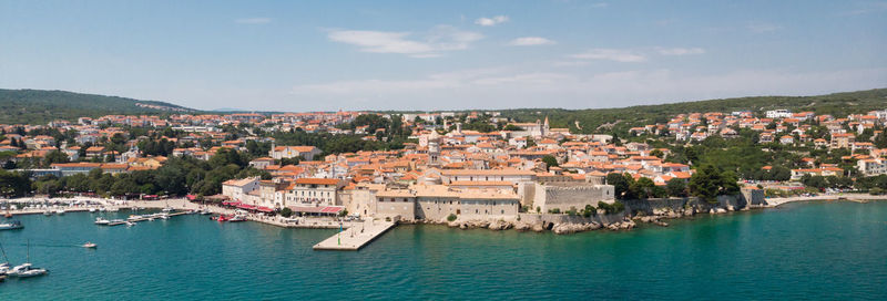 High angle view of townscape by sea