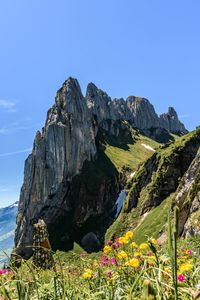 Scenic view of mountain against blue sky